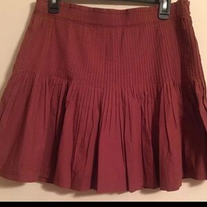 Anthropologie 
Pleated Print Mini Skirt Medium
Chocolate....a cinnamon color
